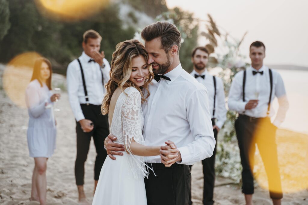 beautiful bride groom having their wedding with guests beach min