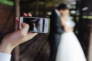 close up mobile taking photo newlyweds min