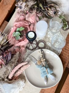 festive table setting with sprigs dried flowers decorative elements min